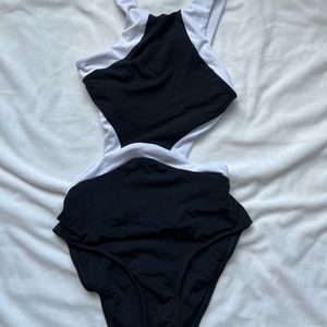 One piece black and white size S, clasp in back, cut outs on sides